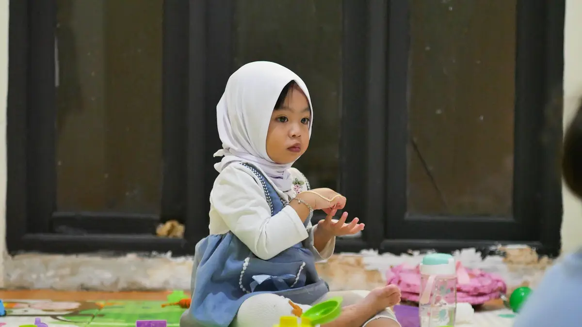 Anak usia dua tahun bermain di lantai kelas
